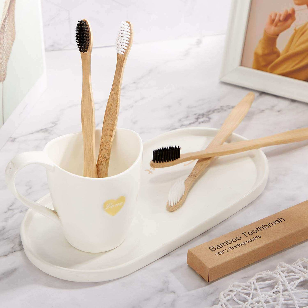 Alkaline World bamboo toothbrush with white handle, BPA-free soft bristles, and natural wooden grip for eco-friendly oral care.