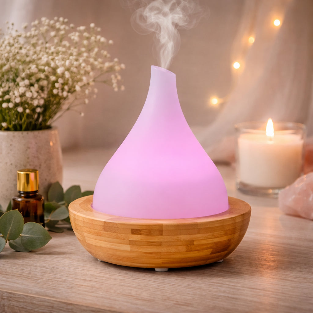 SaltCo Aryya Aromatherapy Ultrasonic Bamboo Diffuser in teardrop shape emitting mist with woodgrain finish.