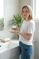 Don Tolman Divine Body Butter jar showing creamy, luxurious texture in a natural setting.