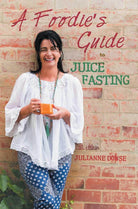 Kuvings brand foodies guide to juice fasting, featuring colorful juice recipes and healthy lifestyle tips on the cover.