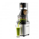 Kuvings CS600 Chef professional cold press juicer on kitchen countertop, showcasing its sleek design and juicing components.