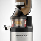 Kuvings CS600 Chef cold press juicer on kitchen countertop, showcasing its sleek design and juicing components.
