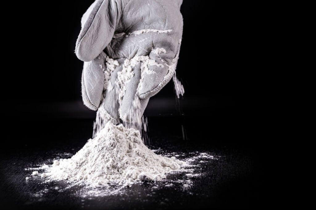 Natural Superfoods ZeoOne Zeolite Powder 500g in a resealable bag, showing fine gray mineral powder for detox and health benefits.